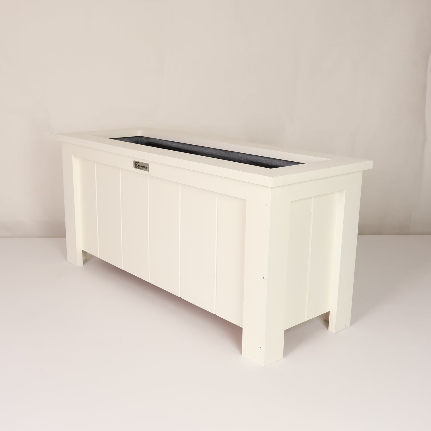 Modern, large, white coloured outdoor planter box, chemical free, made of macrocarpa timber. 