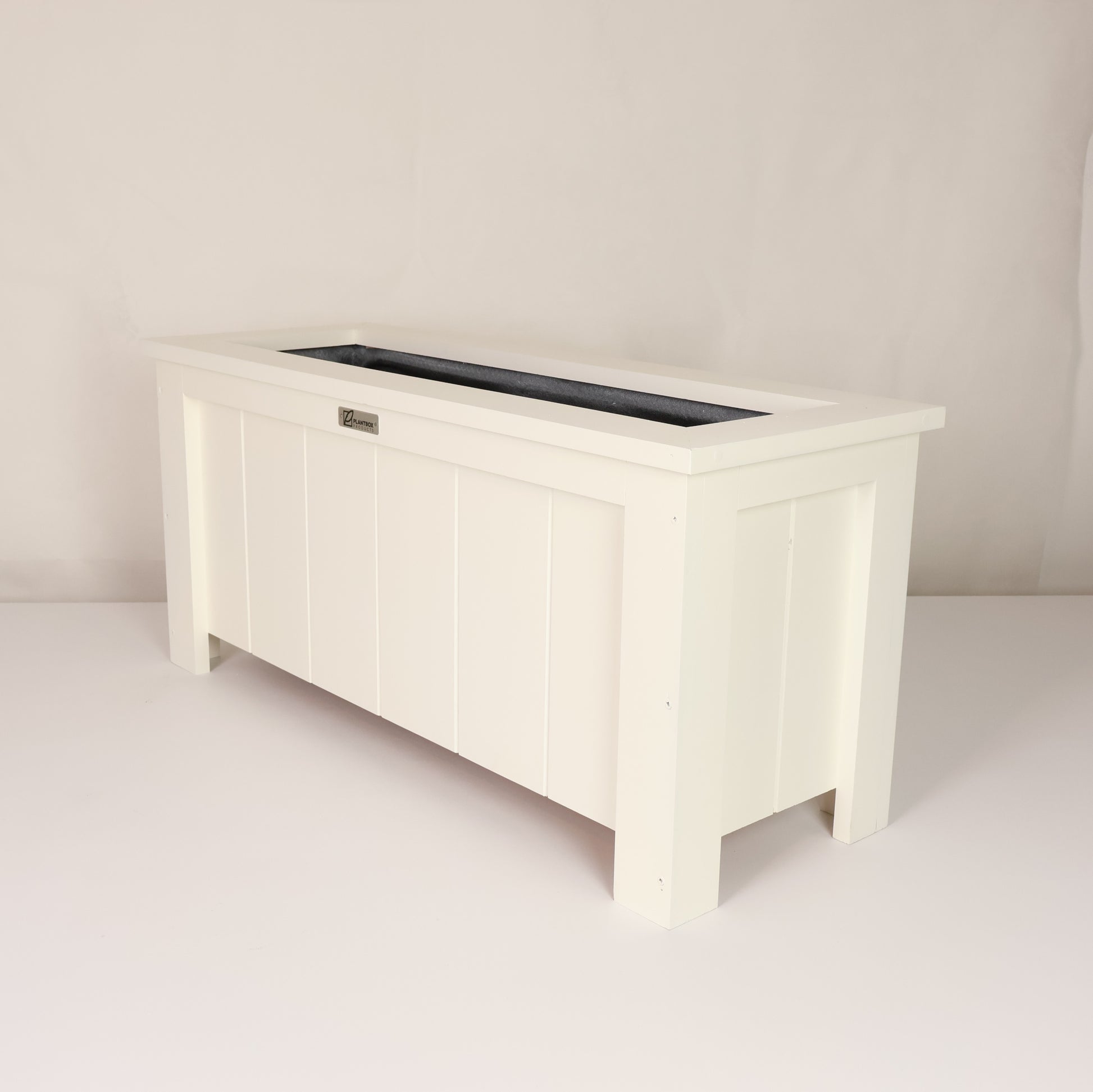 Modern, large, white coloured outdoor planter box, chemical free, made of macrocarpa timber. 