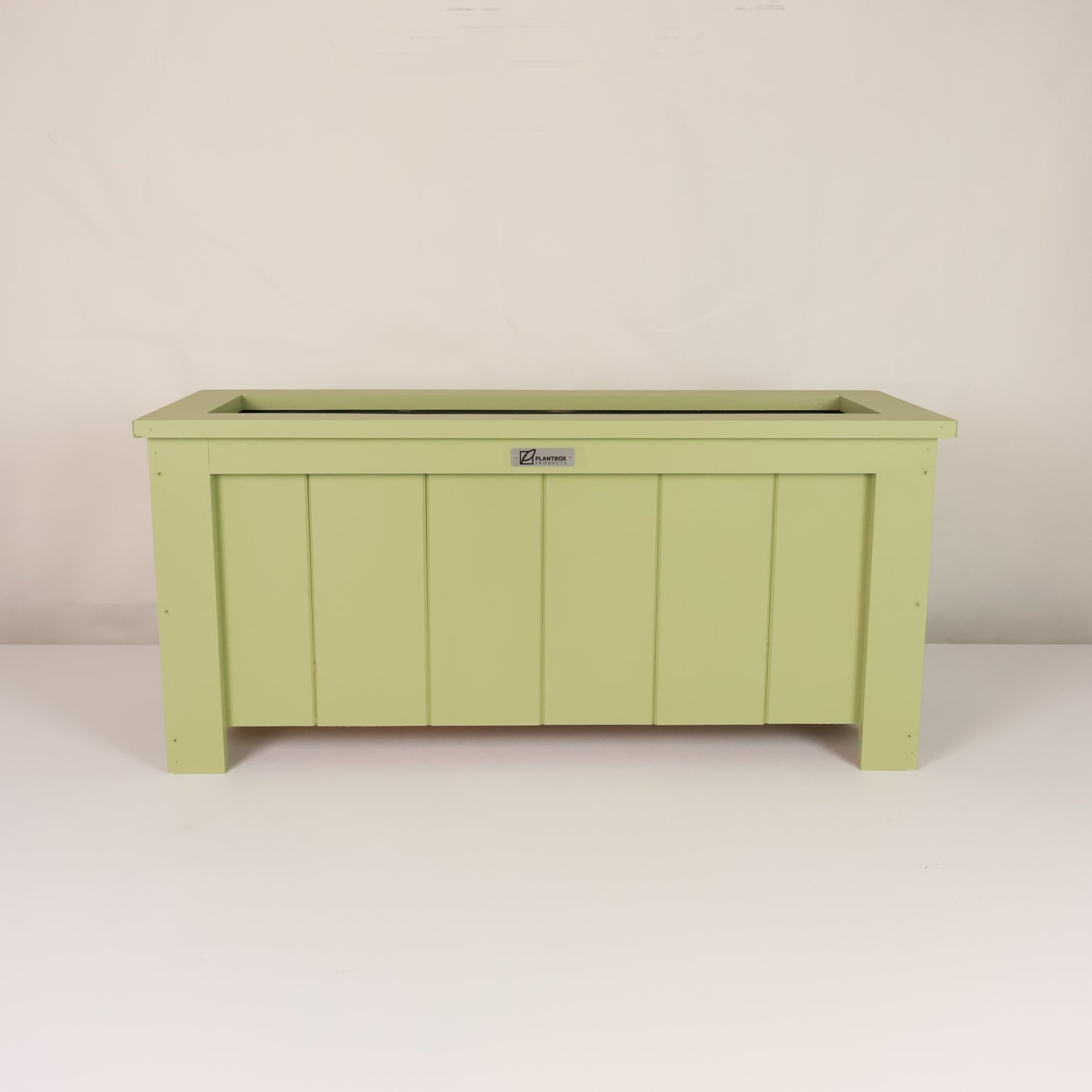 Modern, large, green coloured outdoor planter box, chemical free, made of macrocarpa timber. 