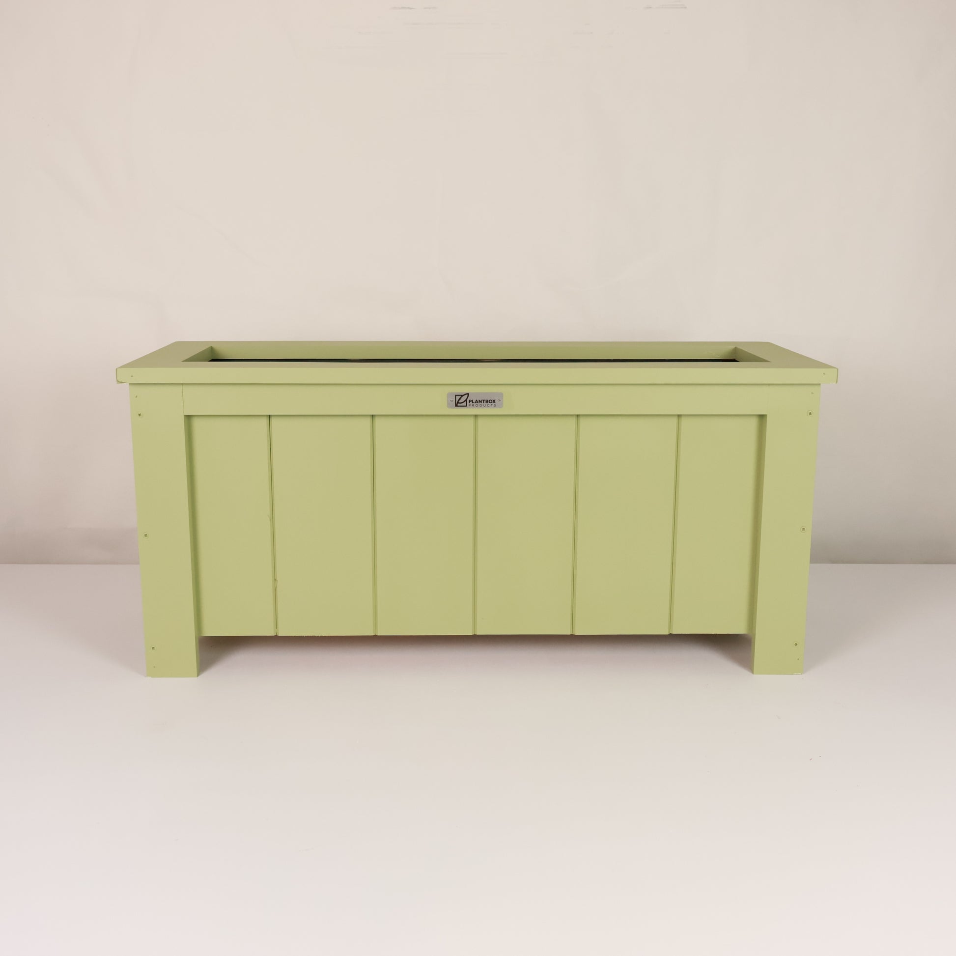 Modern, large, green coloured outdoor planter box, chemical free, made of macrocarpa timber. 