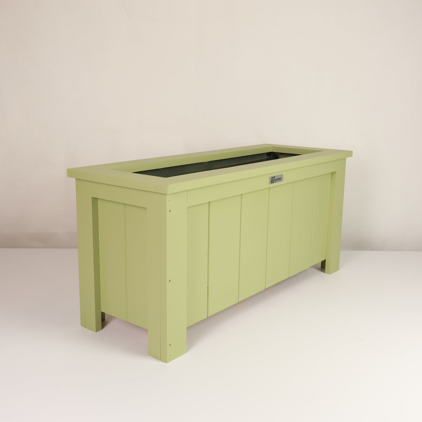 Modern, large, green coloured outdoor planter box, chemical free, made of macrocarpa timber. 