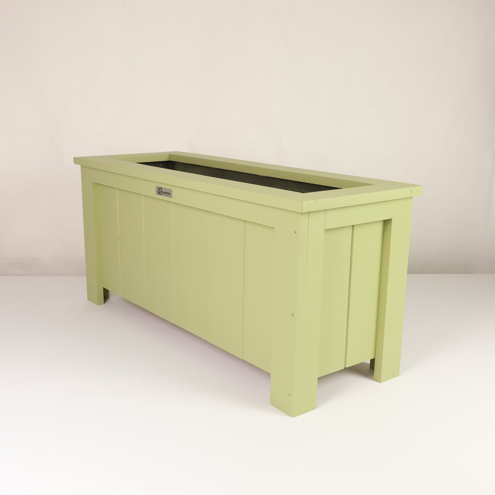 Modern, large, green coloured outdoor planter box, chemical free, made of macrocarpa timber. 