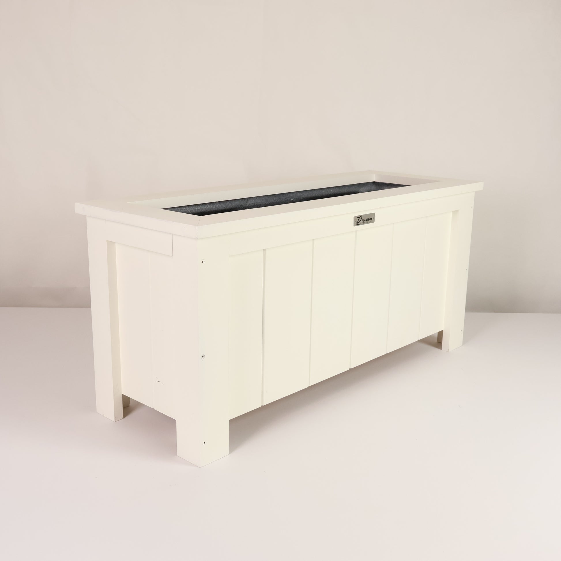 Modern, large, white coloured outdoor planter box, chemical free, made of macrocarpa timber. 